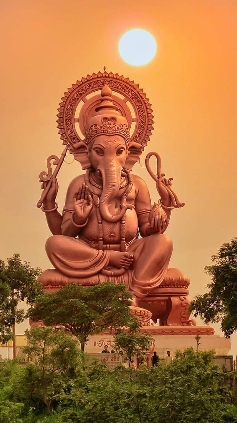 Lord Ganesha at sunset, golden statue