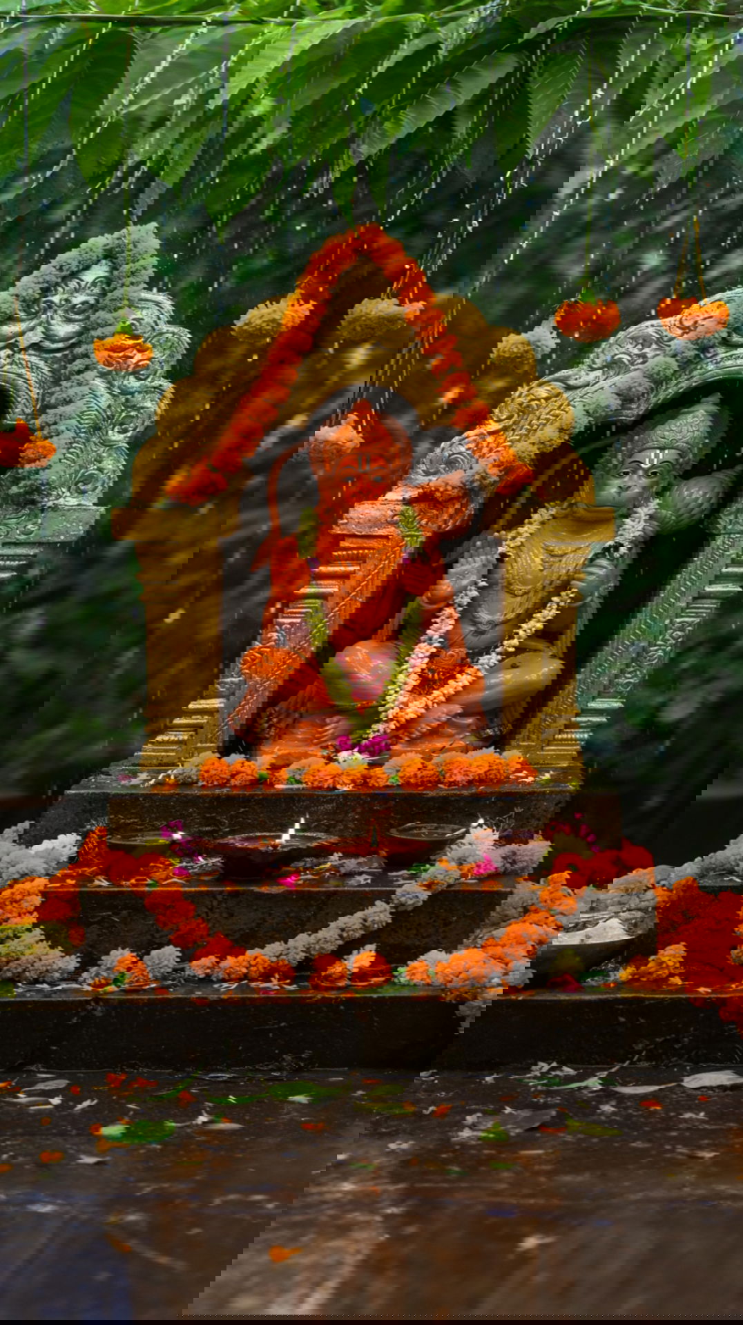 Hanuman statue adorned with marigold flowers