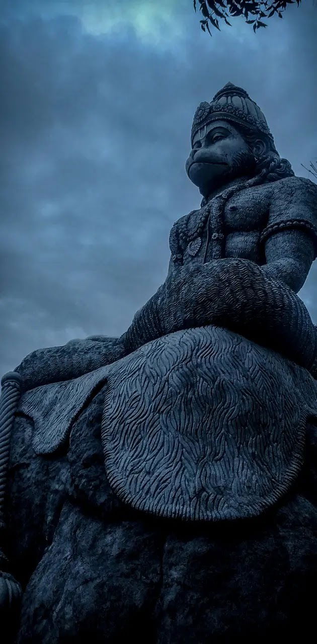 Hanuman statue overlooking cloudy sky