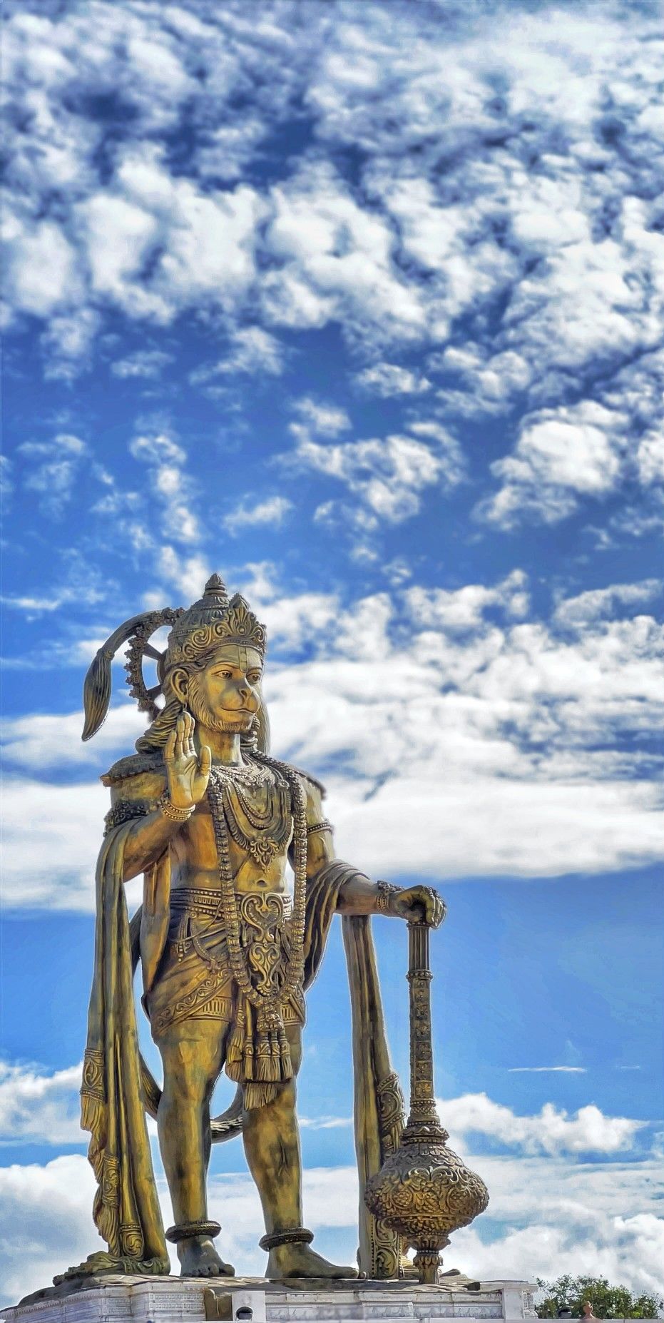 Hanuman statue against a cloudy sky