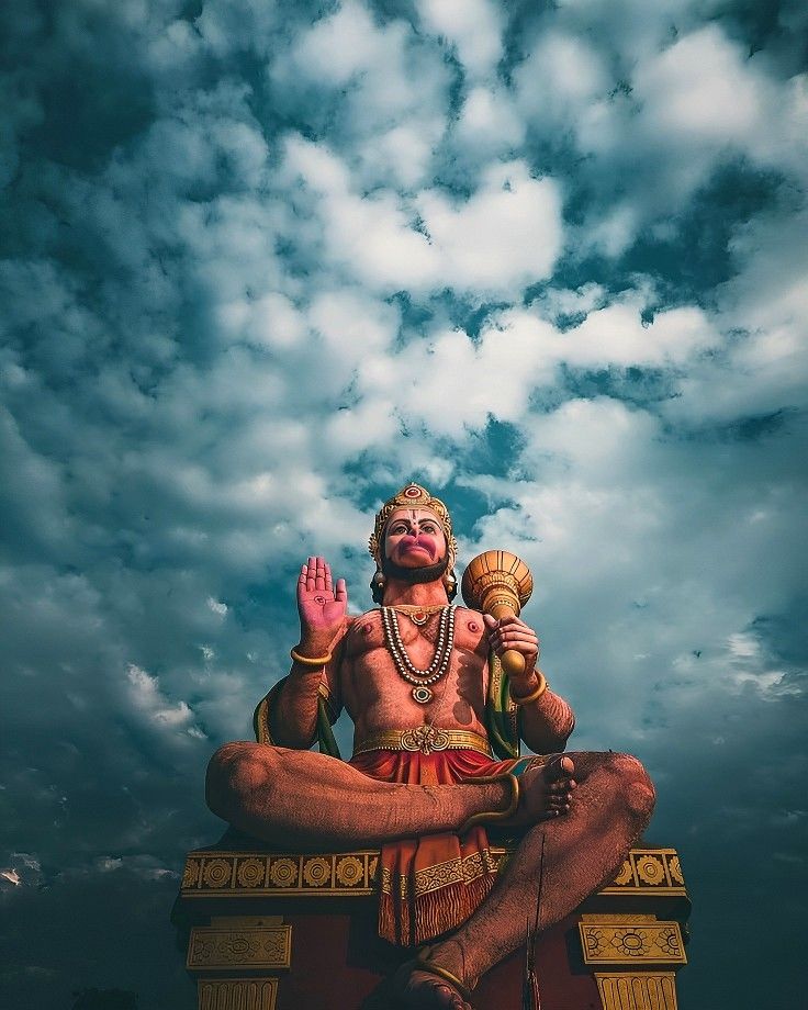 Hanuman meditating amidst dramatic clouds