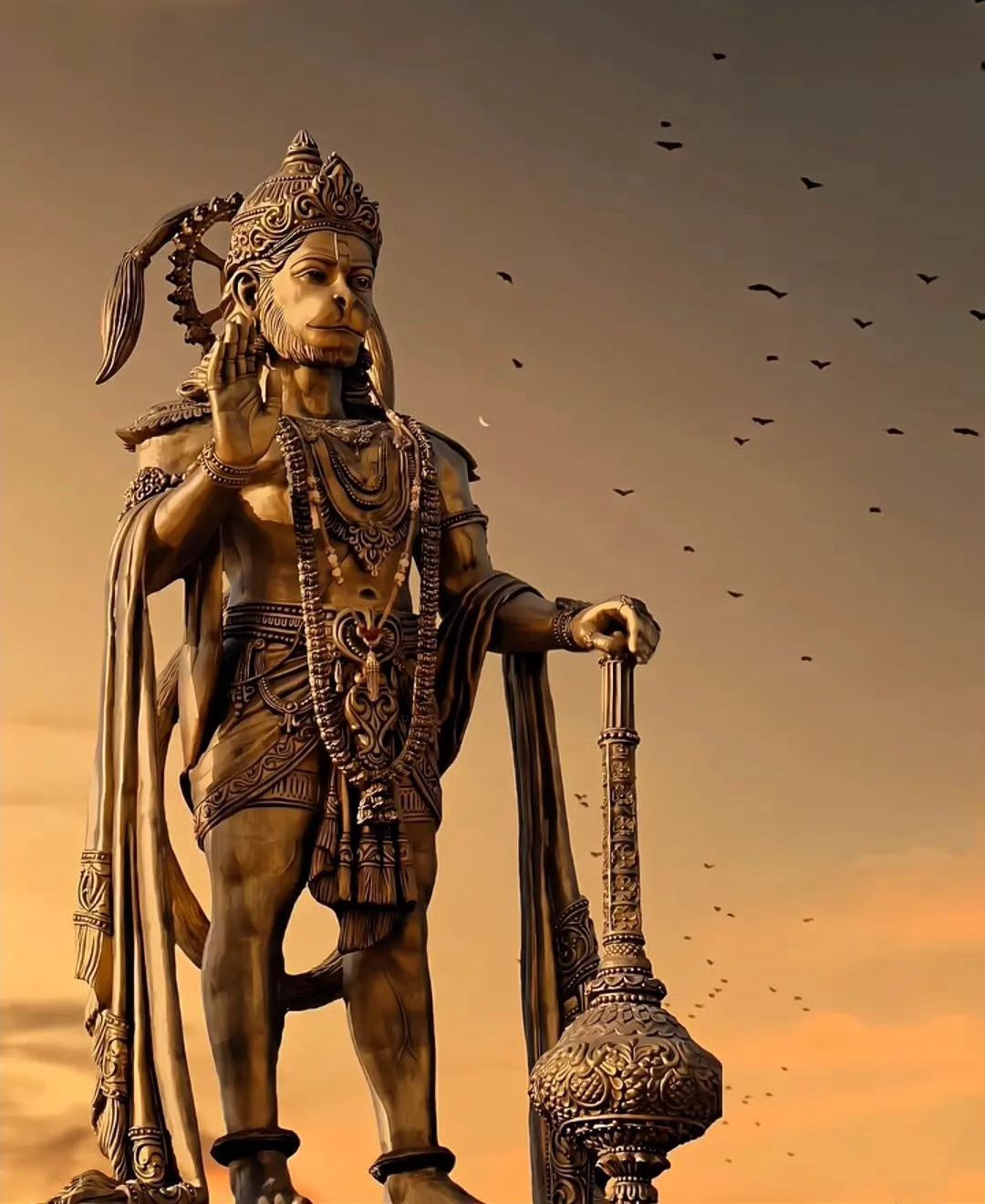 Majestic Hanuman statue against sunset sky