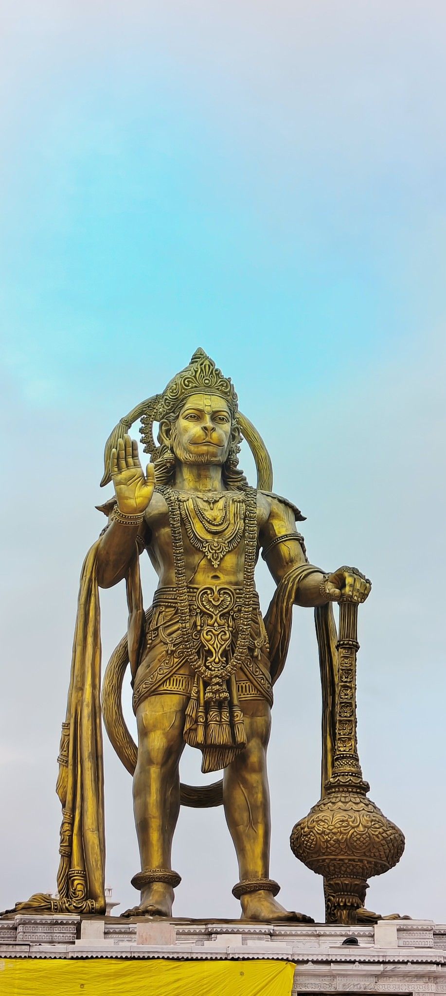 Golden Hanuman statue, divine protector.