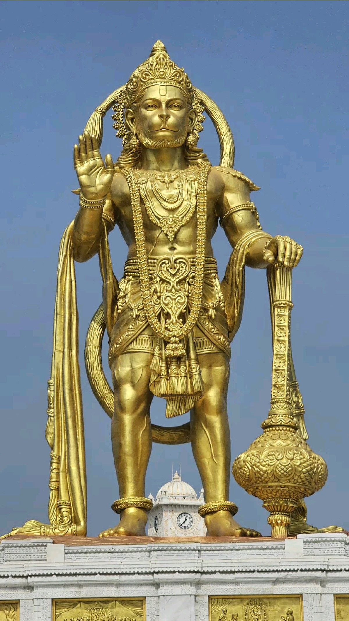 Golden Hanuman statue, blessing devotees.