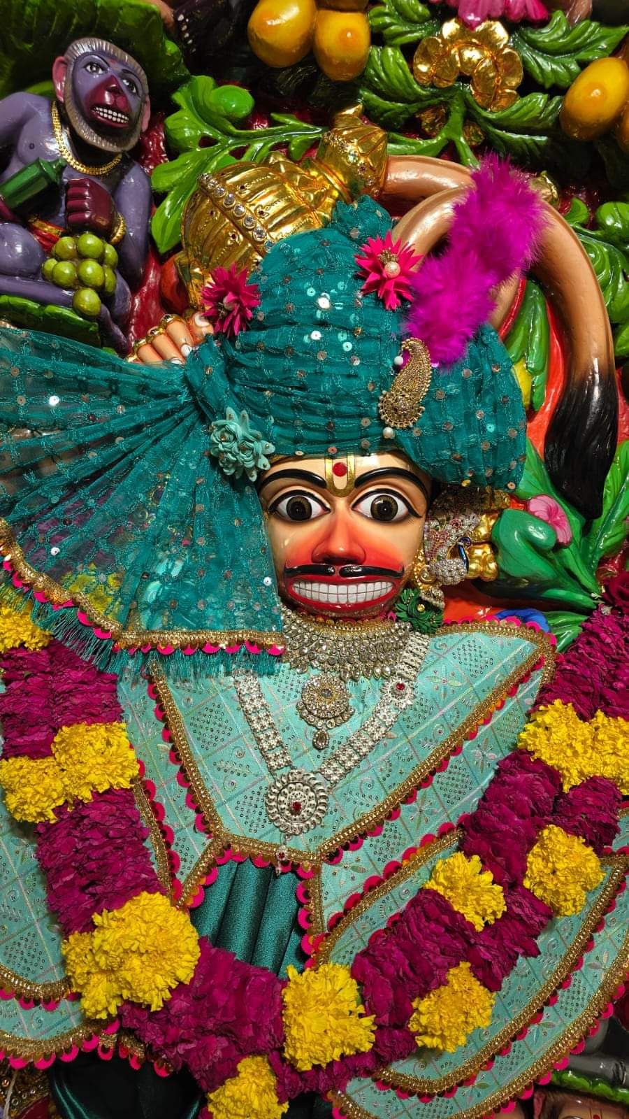 Hanuman adorned with flowers and fruits.
