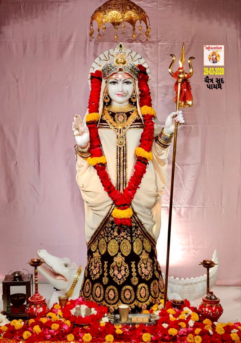 Khodiyar Maa statue adorned with flowers.