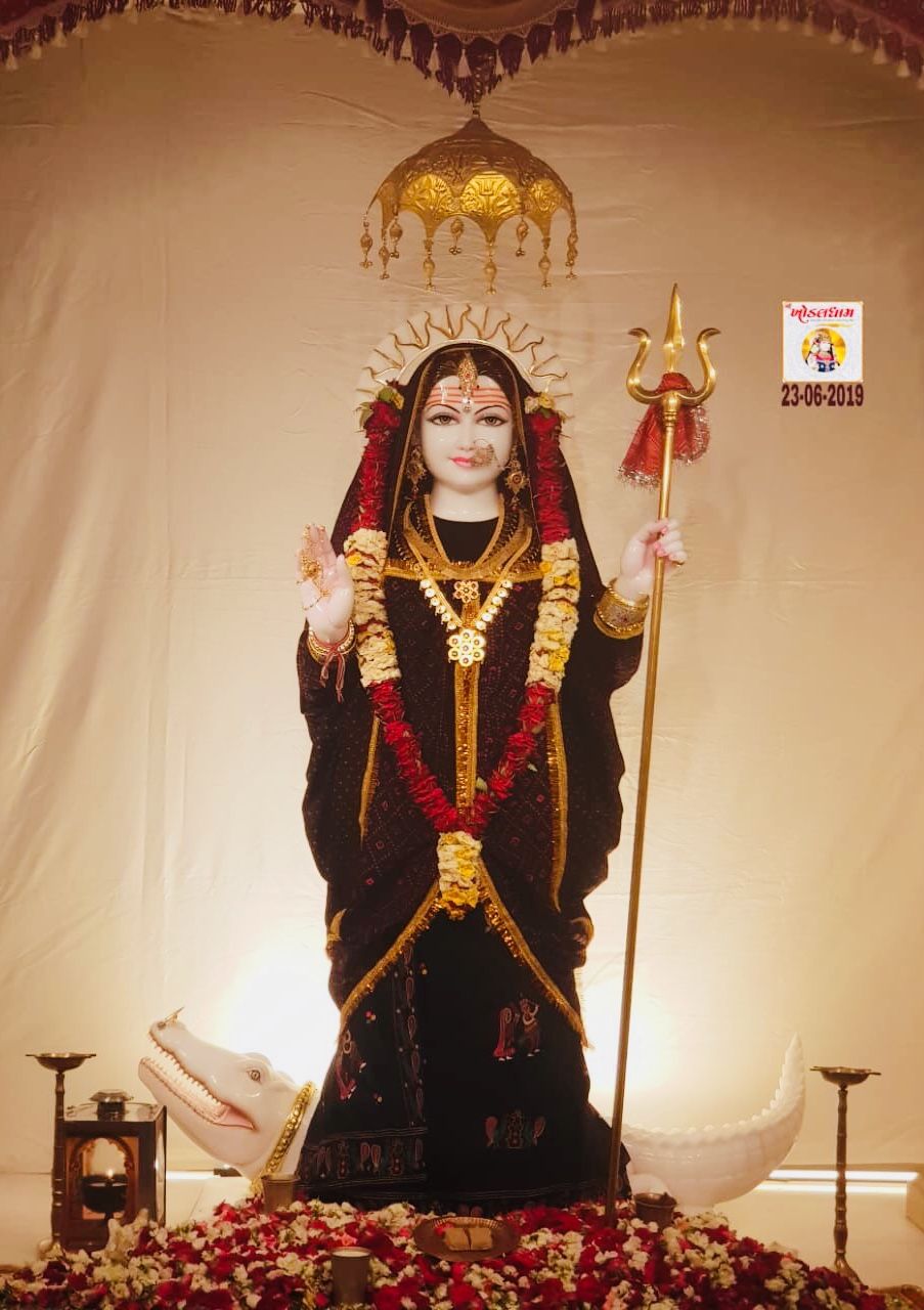 Khodiyar Maa statue adorned with flowers.