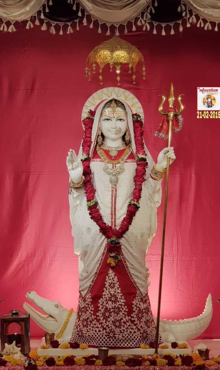 Khodiyar Maa statue with floral garland.