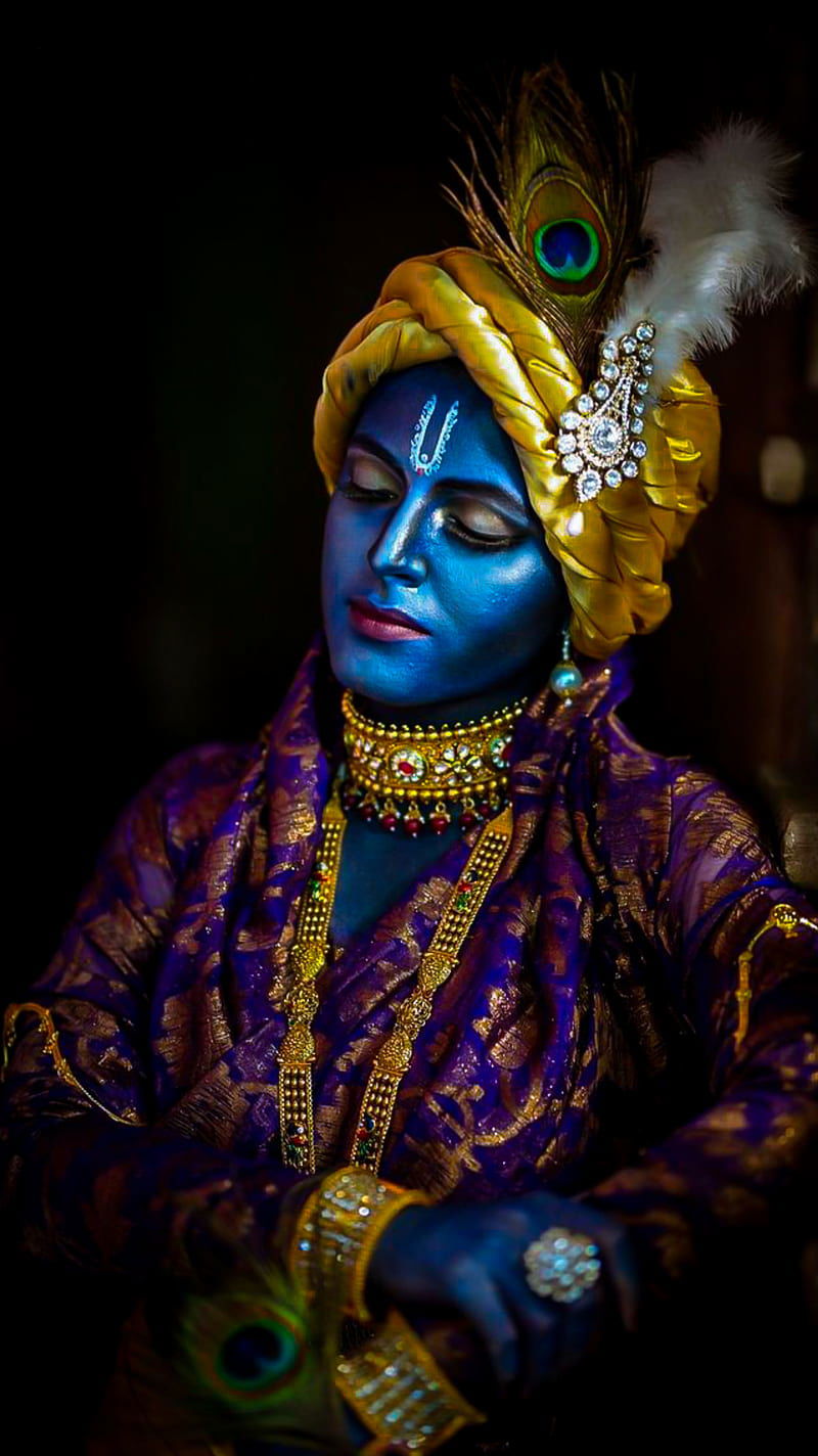 Blue-skinned Krishna with peacock feather.