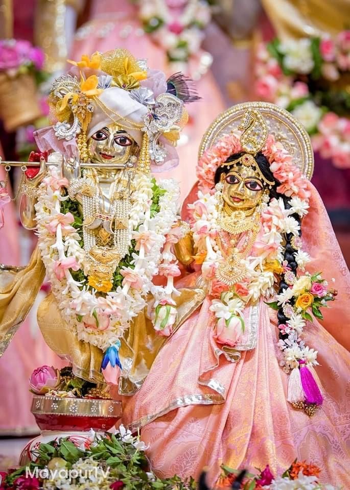 Radha Krishna deities with flower garlands