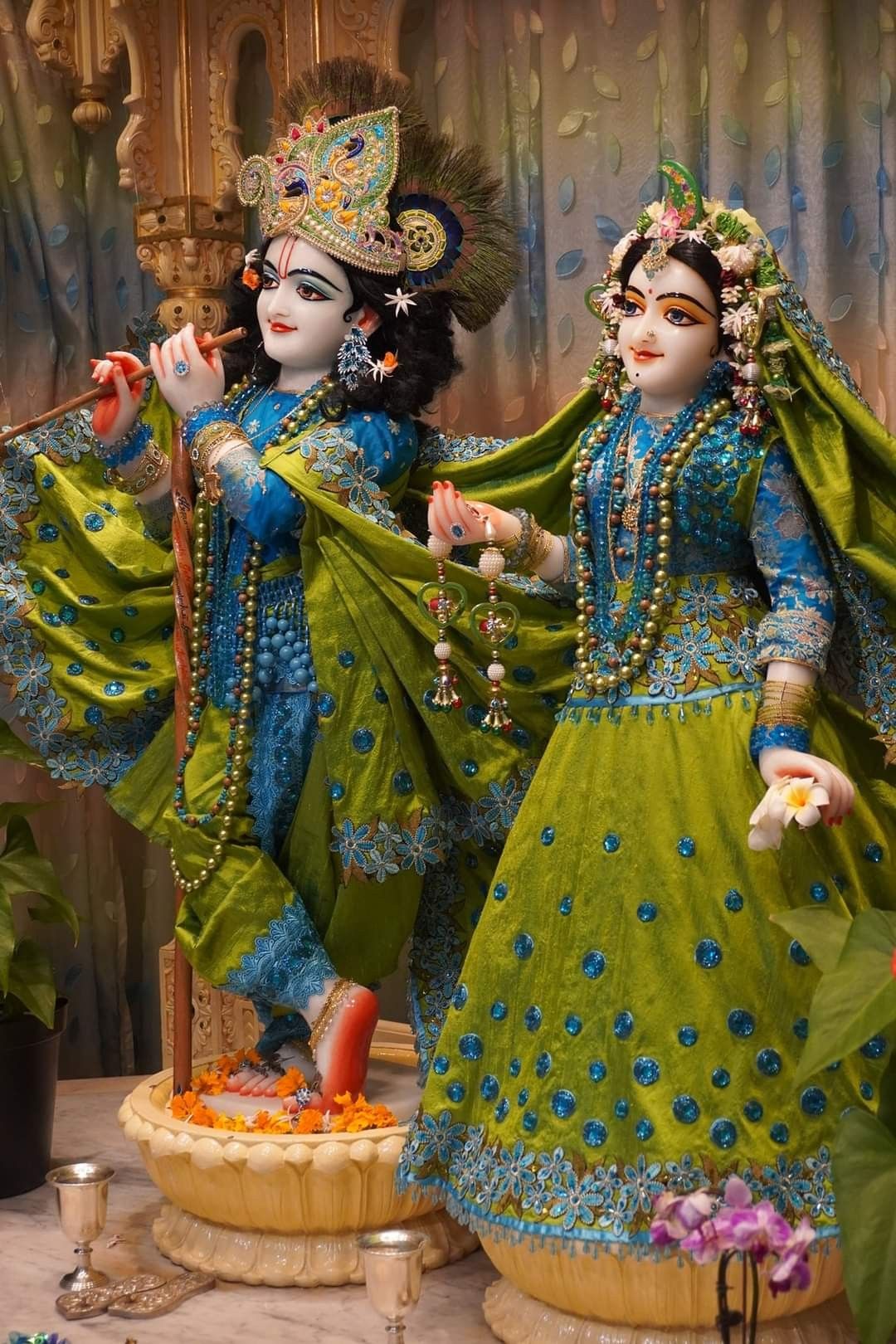 Radha Krishna idols with flute and flowers