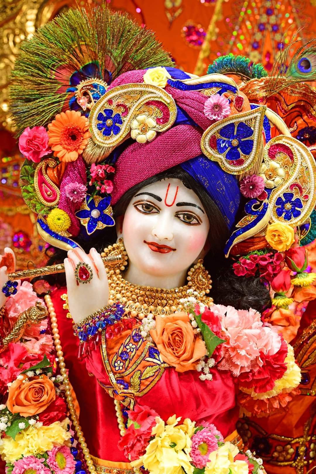 Krishna adorned with flowers and feather