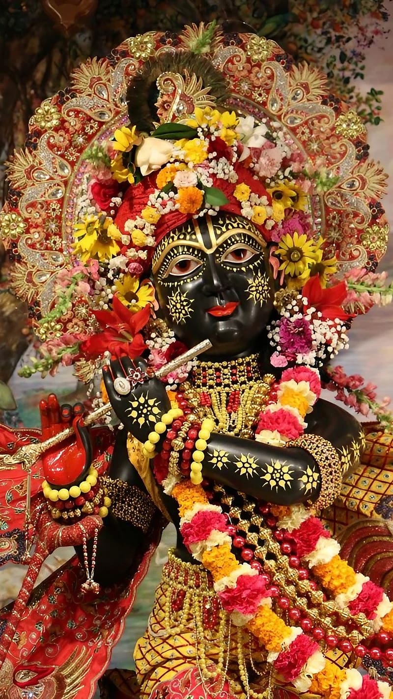 Krishna adorned with vibrant floral garlands