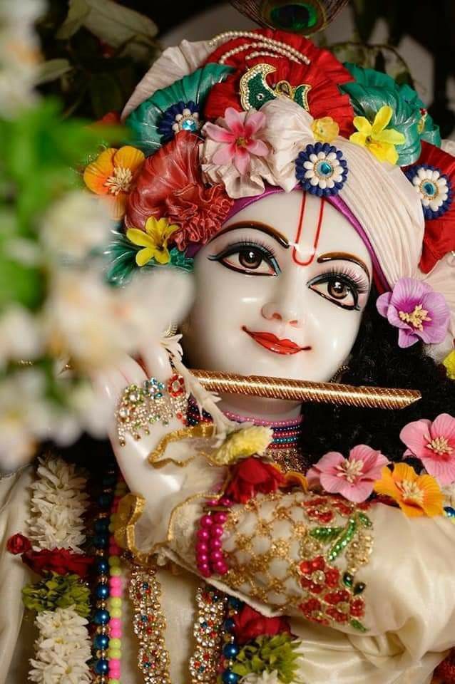 Krishna playing flute with flower garland