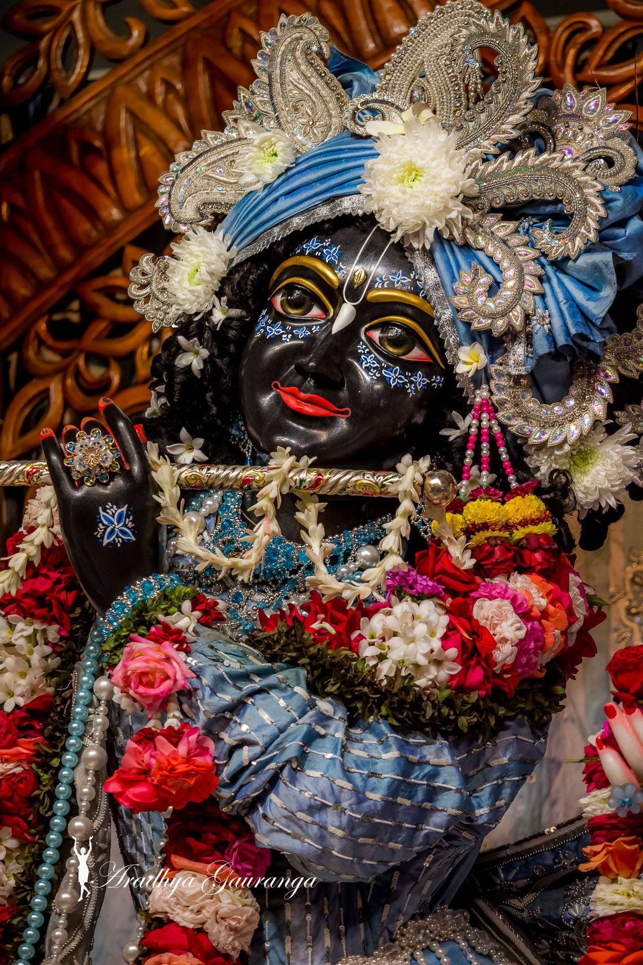 Krishna adorned with vibrant flowers
