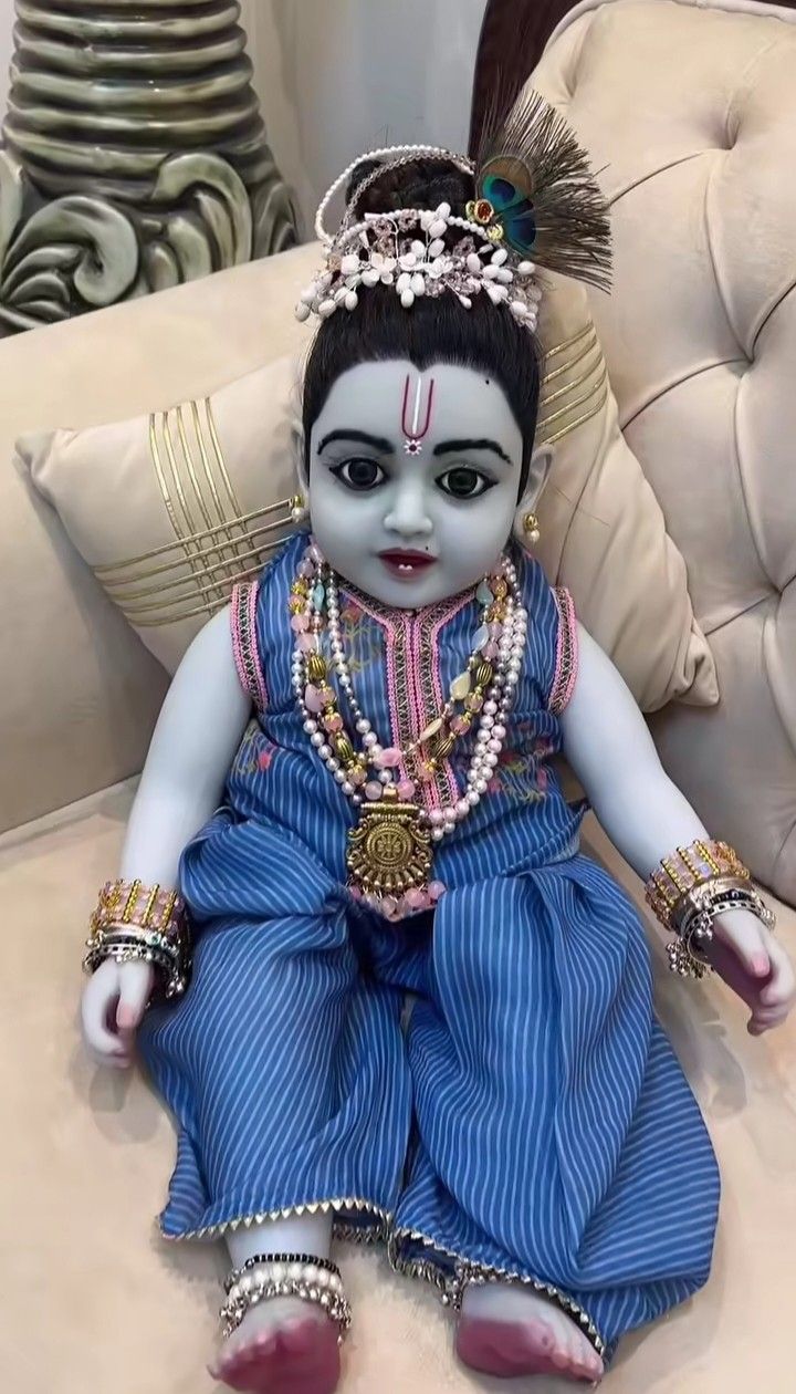 Baby Krishna with floral garland