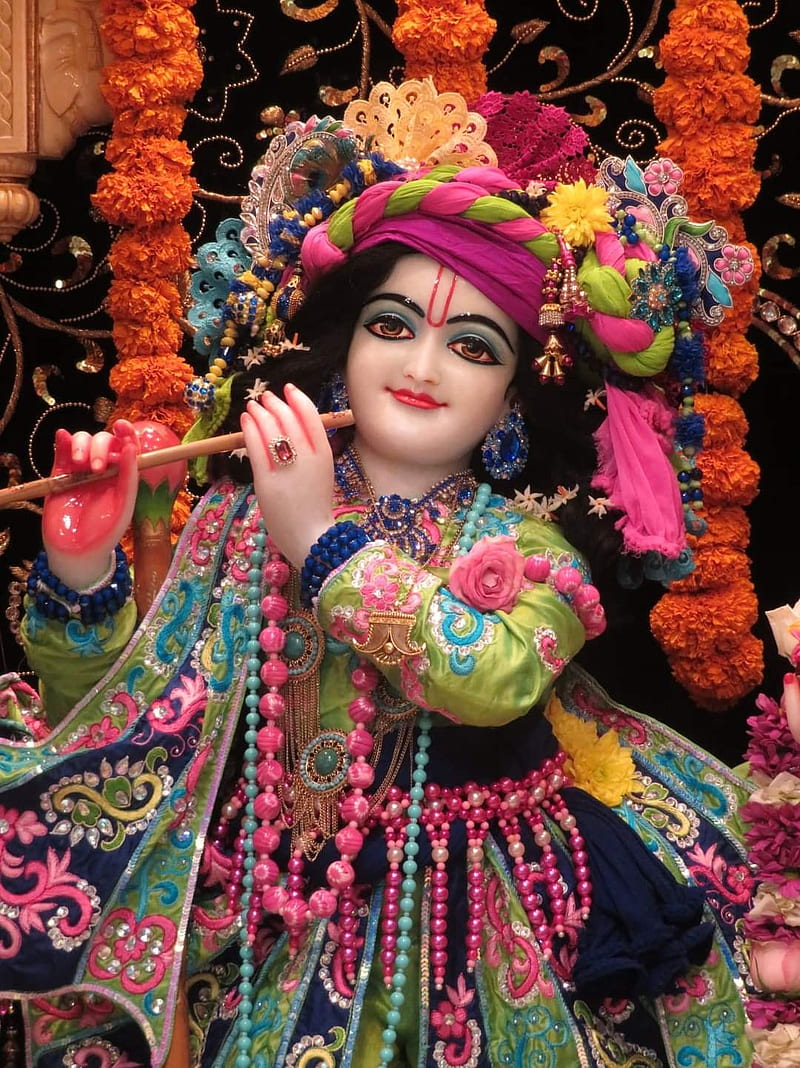 Lord Krishna playing flute with peacock feather