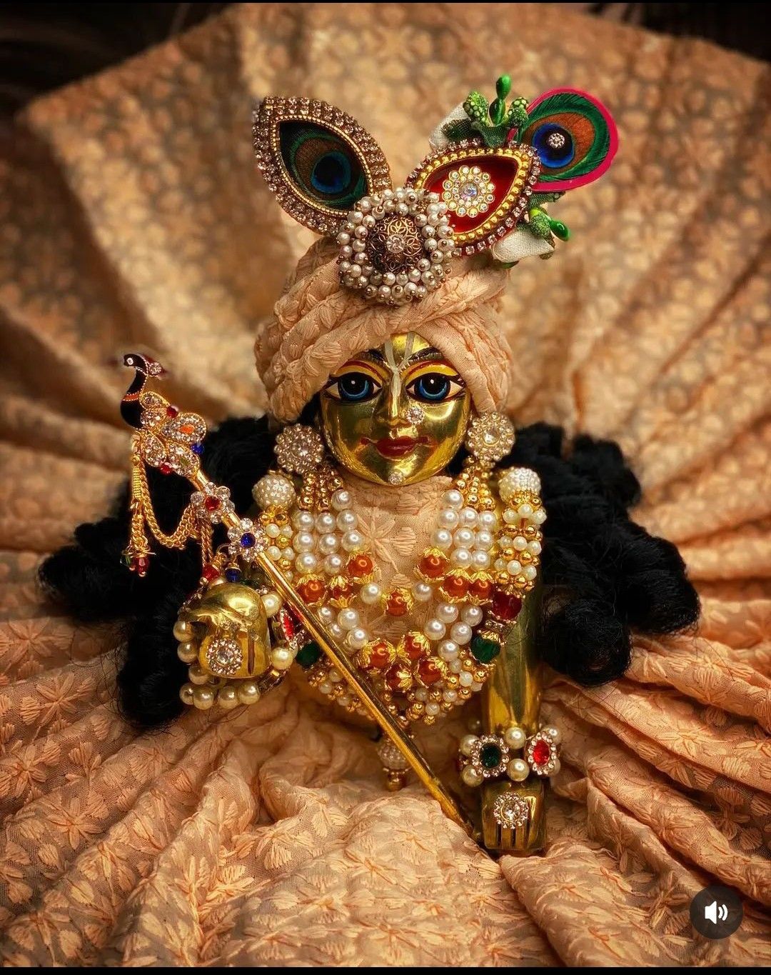 Decorated Krishna idol with peacock feather.