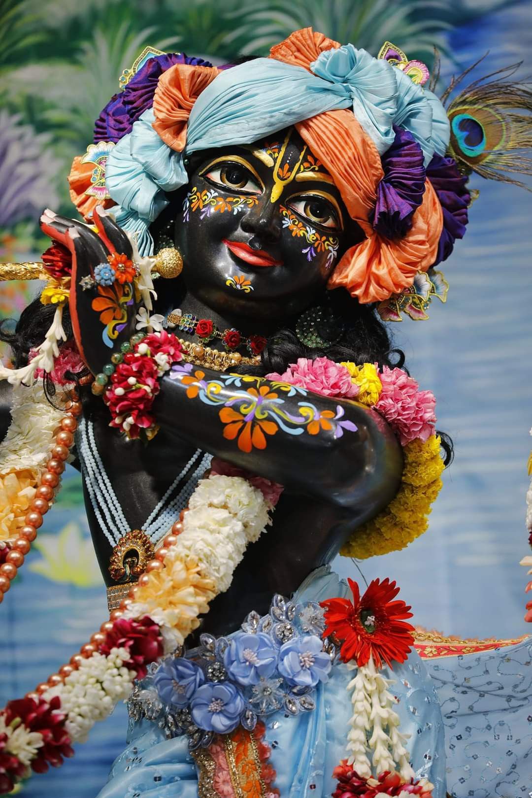 Krishna adorned with floral garland.