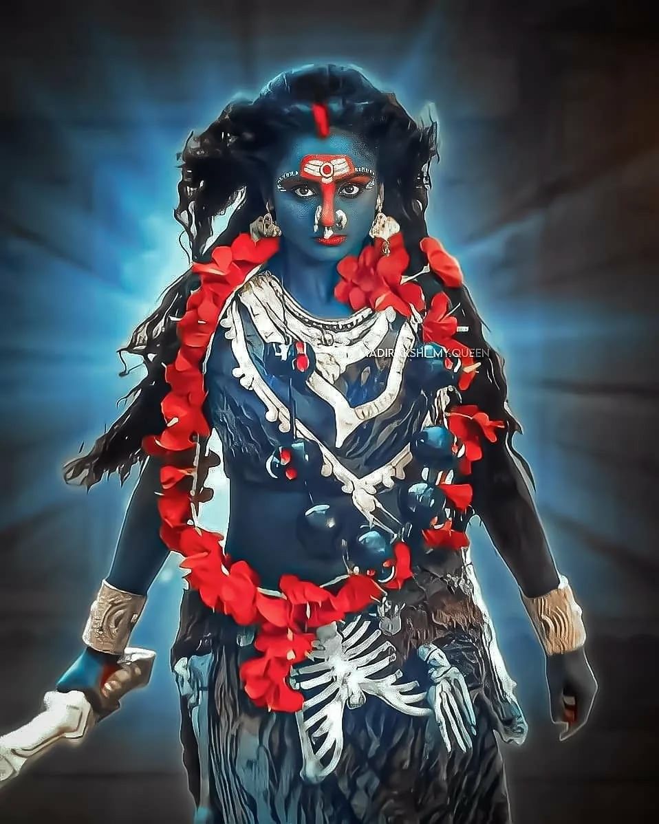 Fierce Mahakali Maa with trident and flowers.