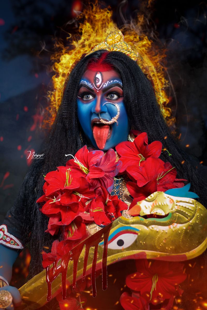 Mahakali Maa with red flowers, fierce gaze.
