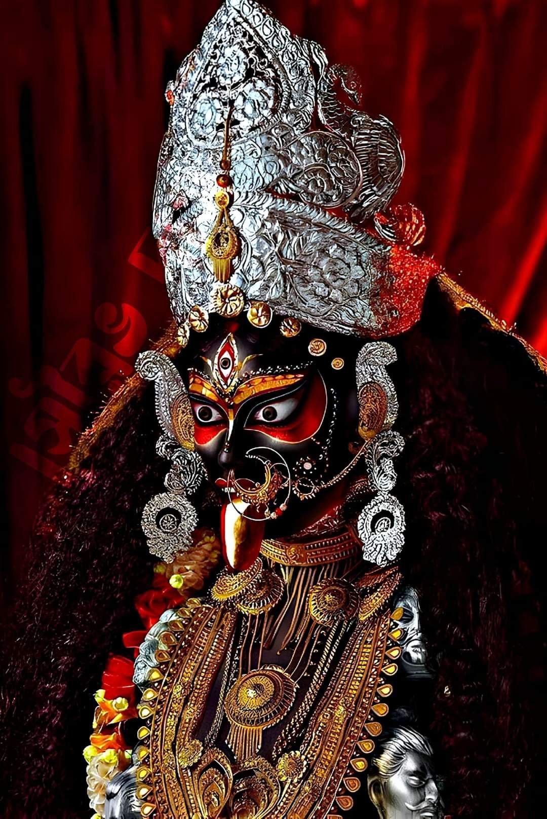 Mahakali Maa with silver crown and red backdrop