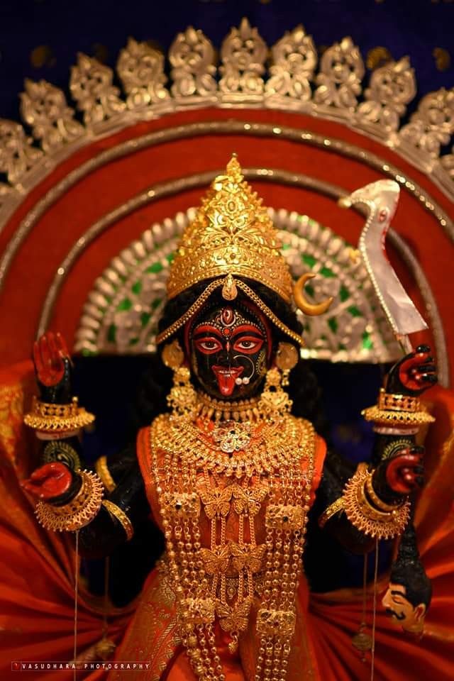Goddess Kali idol with golden ornaments.