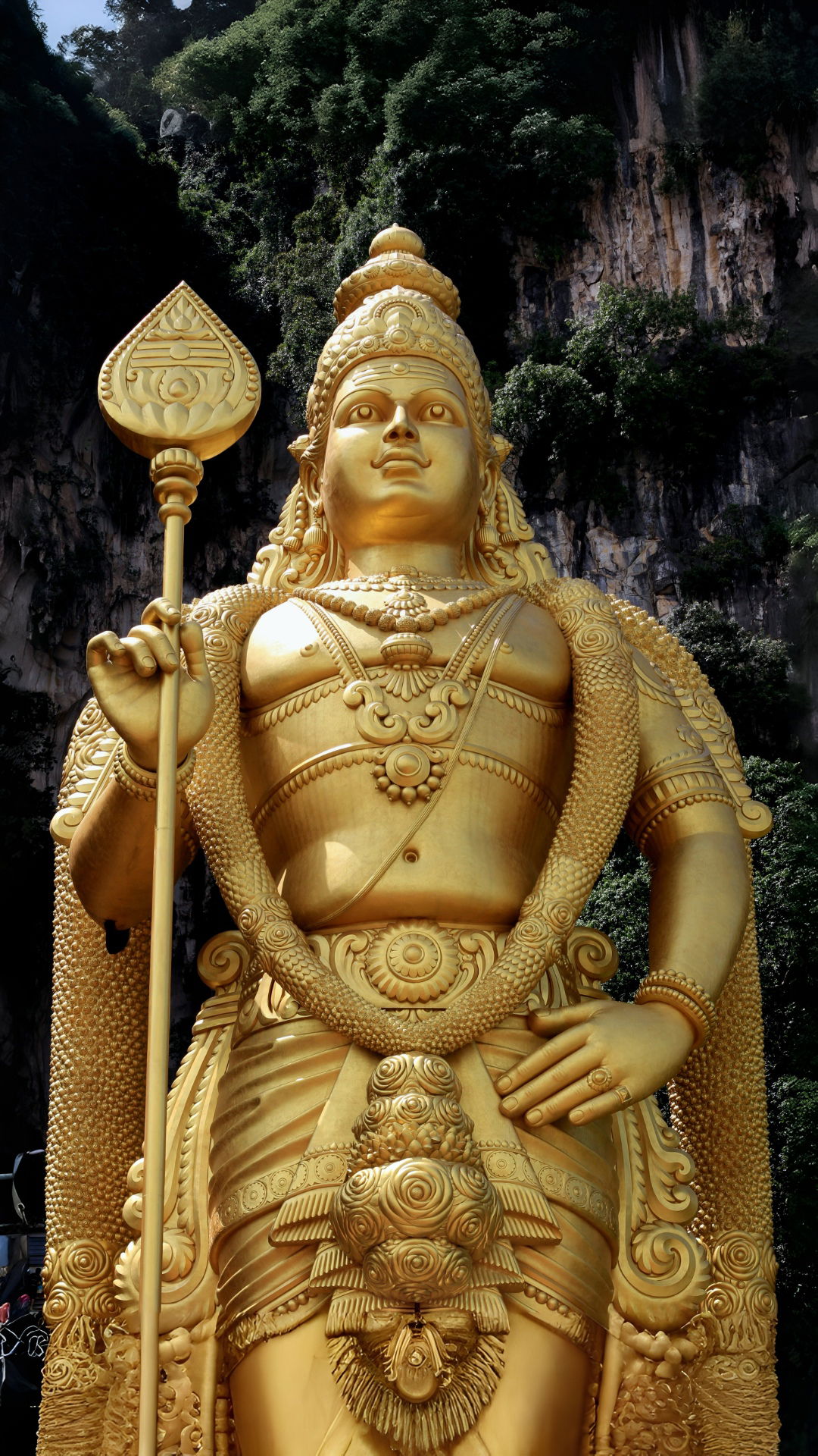 Golden Murugan statue with Vel spear