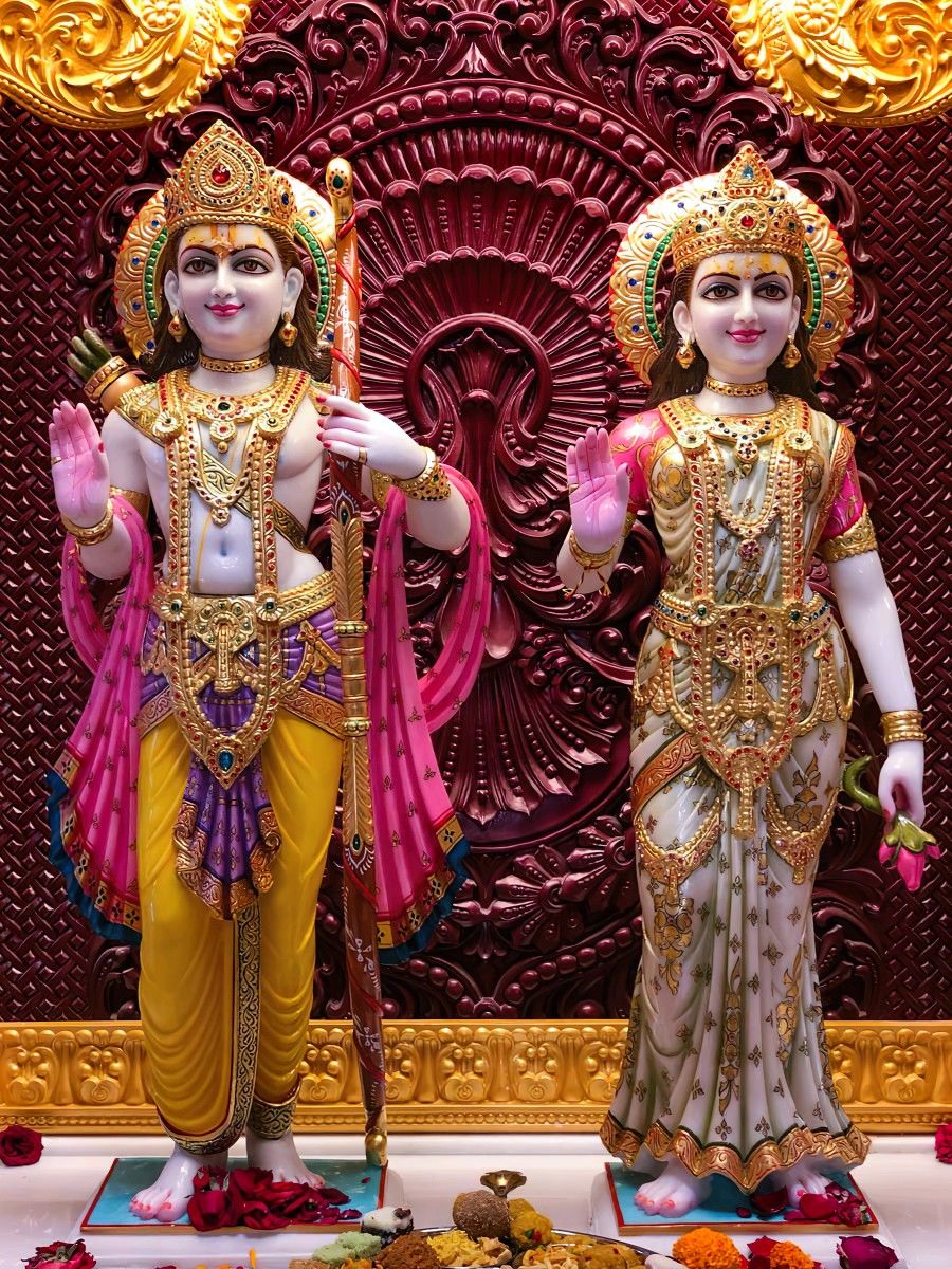Ram and Sita marble statue with flowers