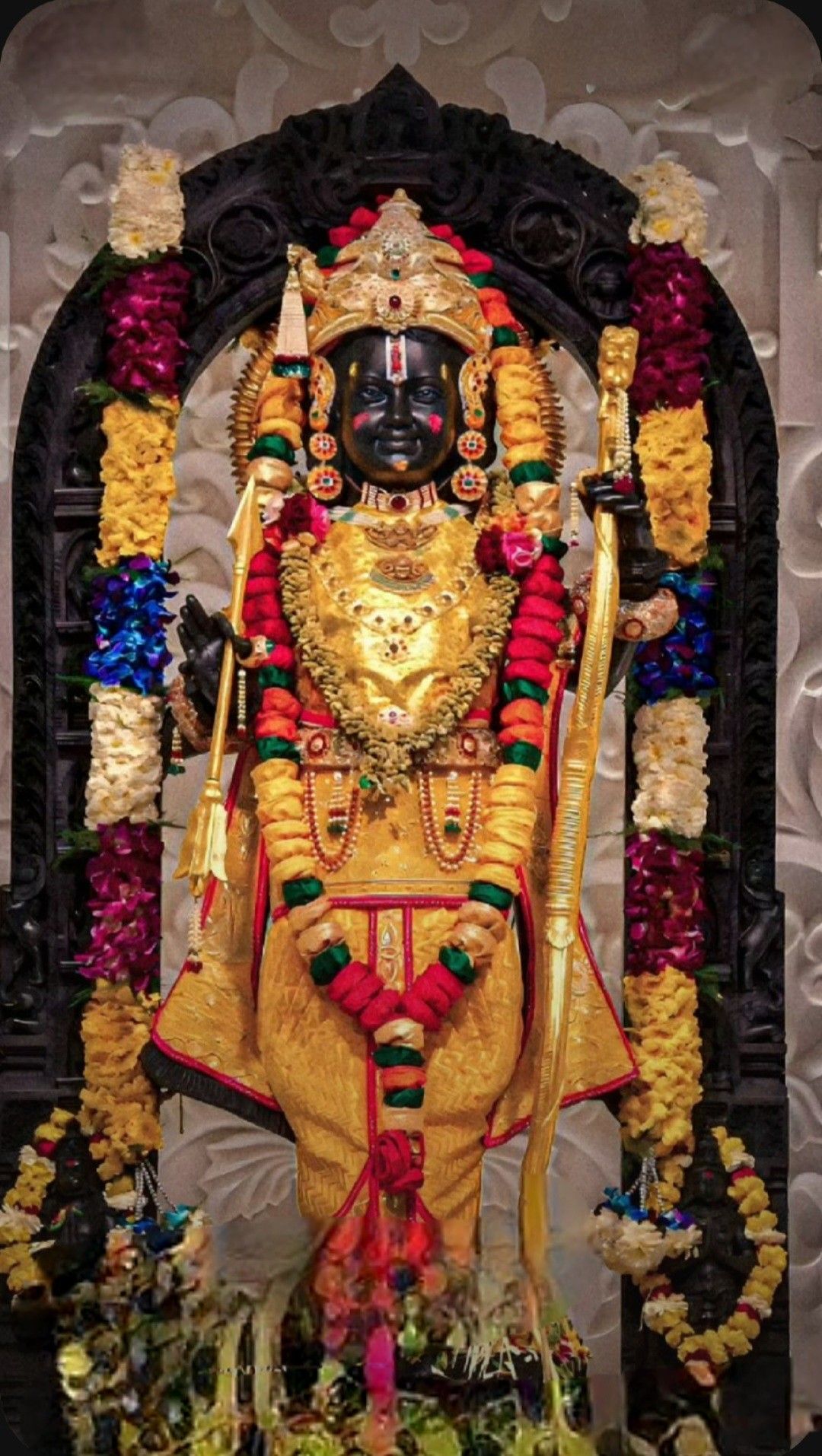 Lord Ram golden statue with flowers