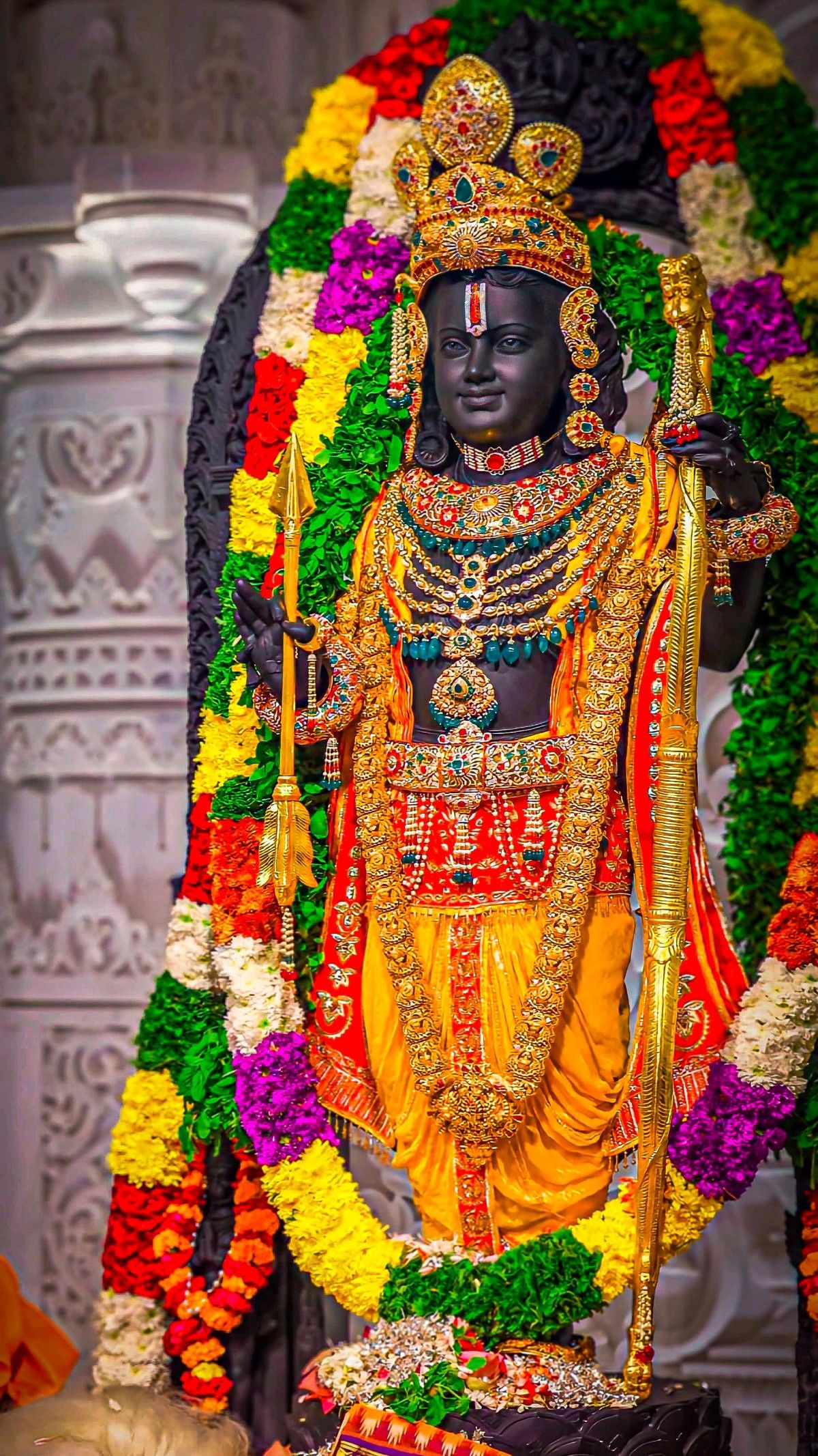 Lord Ram statue adorned with flowers.
