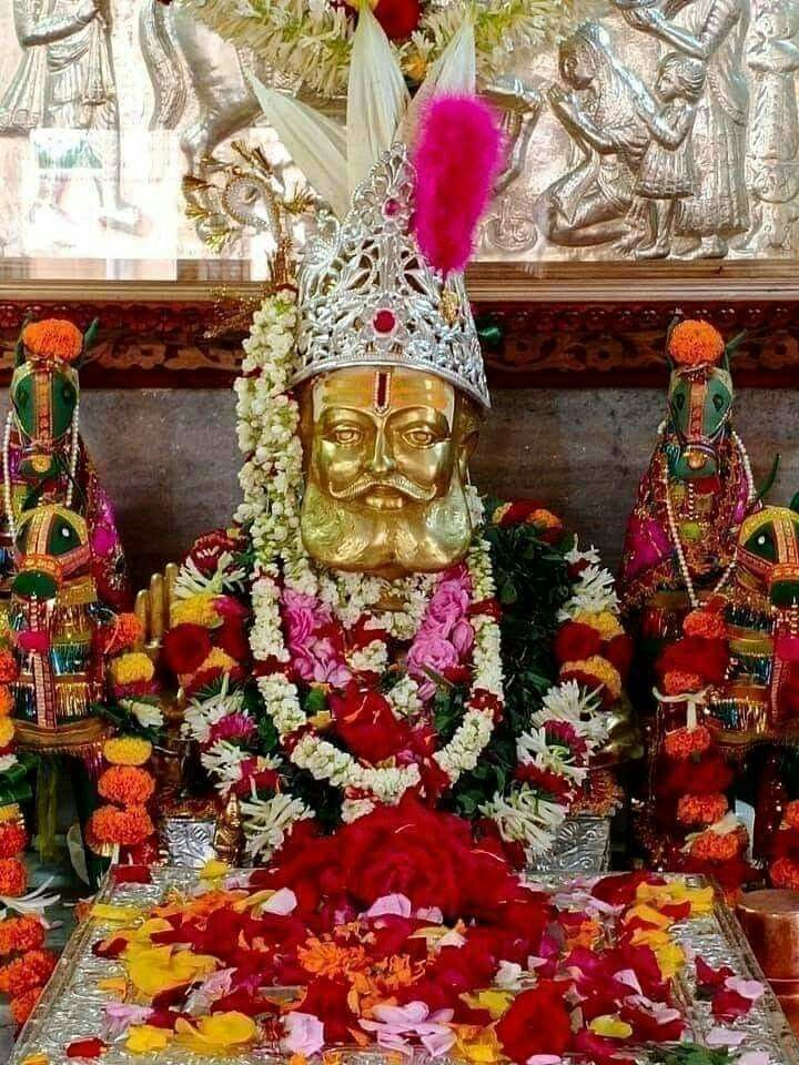 Golden Ramdevpir statue with flower garland