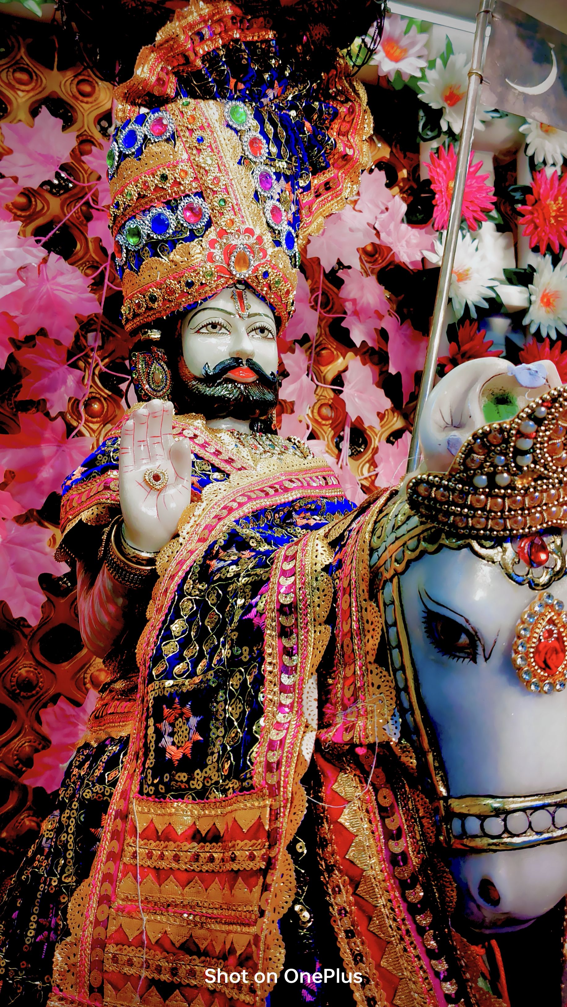 Ramdevpir idol with floral decorations.