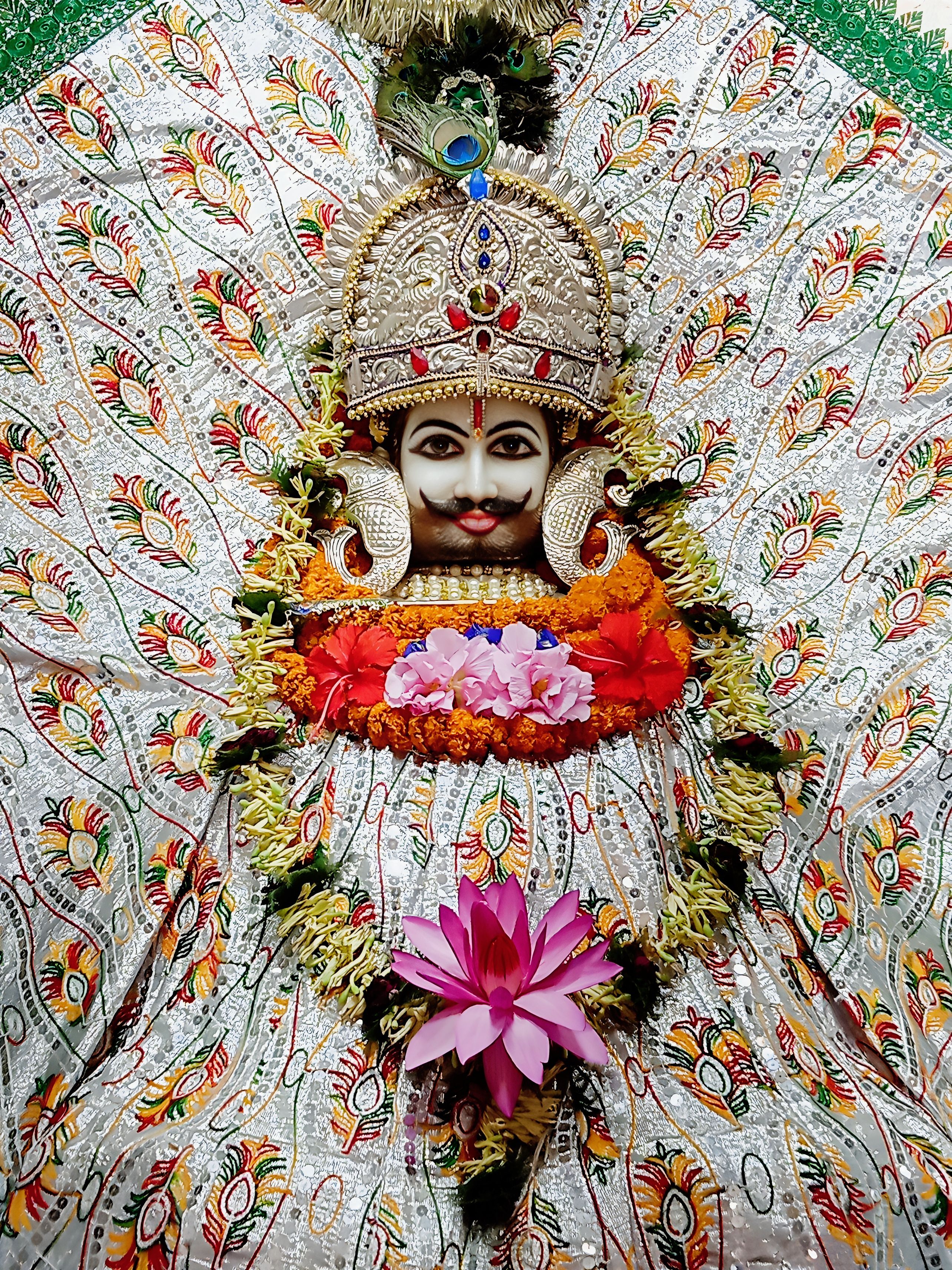 Ramdevpir with flowers and silver backdrop