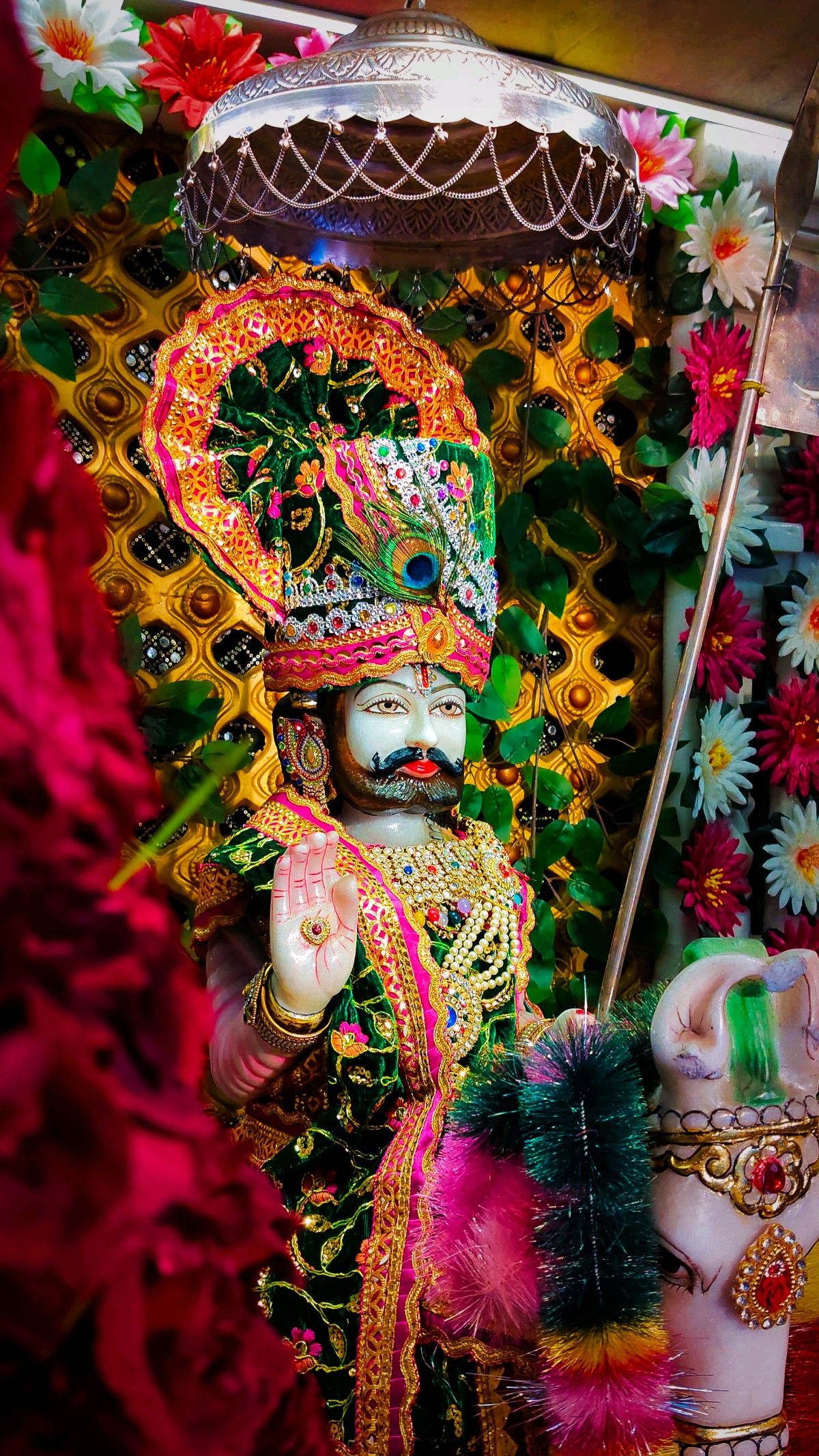 Ramdevpir adorned with flowers and garlands