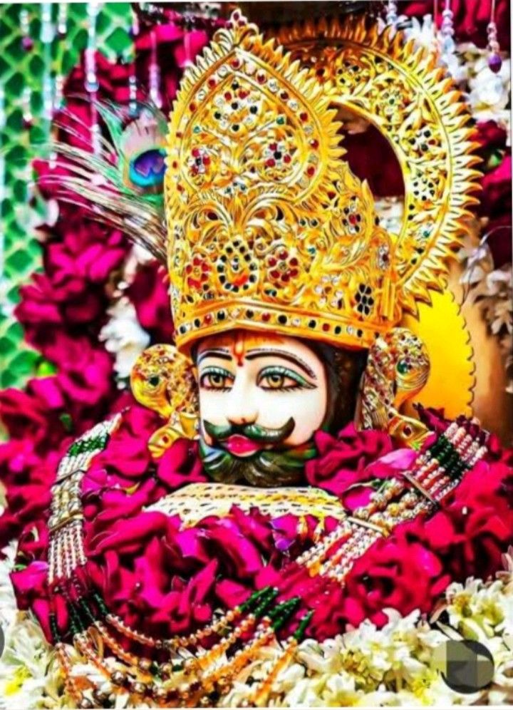 Ramdevpir with ornate headgear and flowers