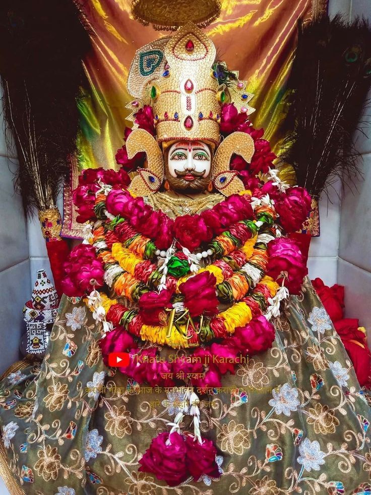 Radiant portrait of Ramdevpir adorned with flowers.