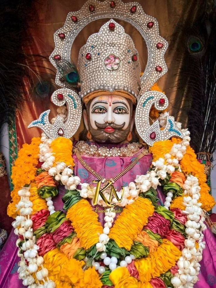 Ramdevpir with floral decorations and crown.