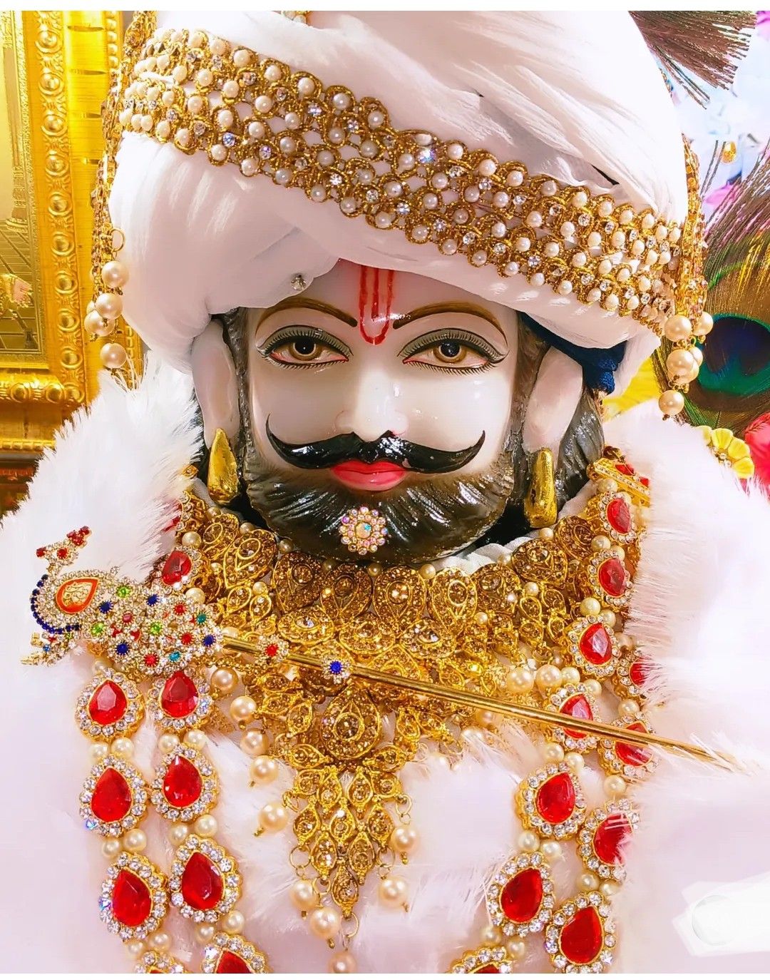 Close-up of Ramdevpir\'s adorned face.
