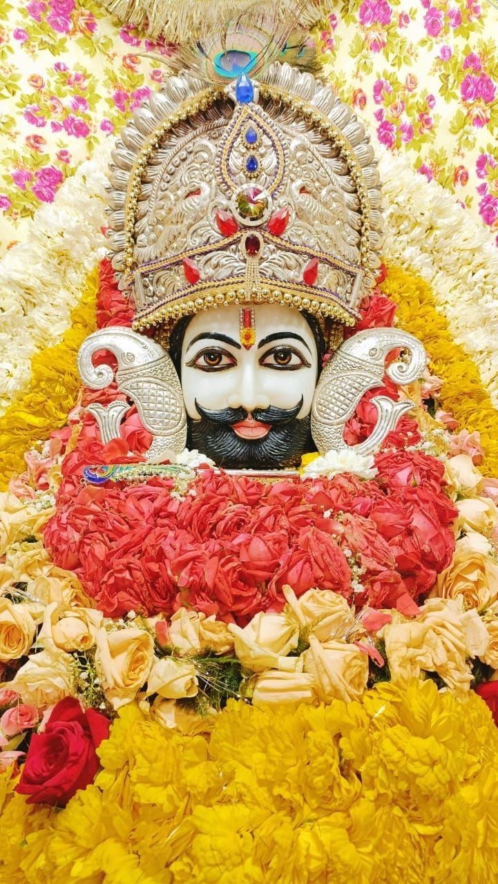 Ramdevpir amidst beautiful floral arrangements