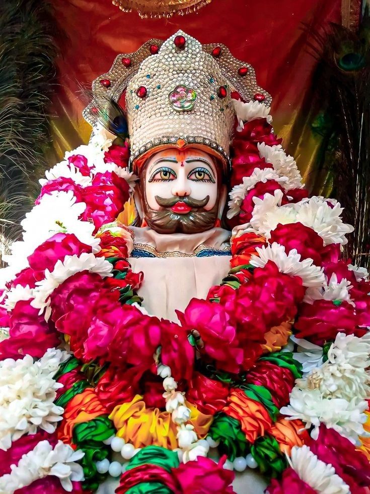 Ramdevpir with flower garland, divine portrait.