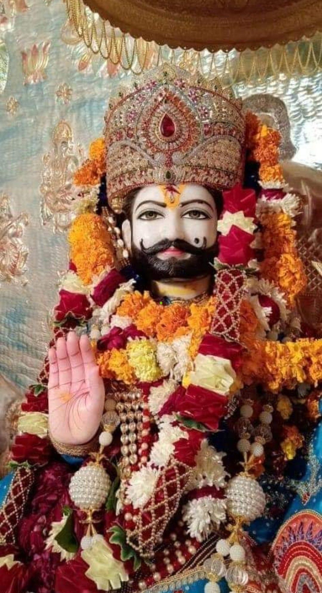 Close-up portrait of Ramdevpir with blessing.