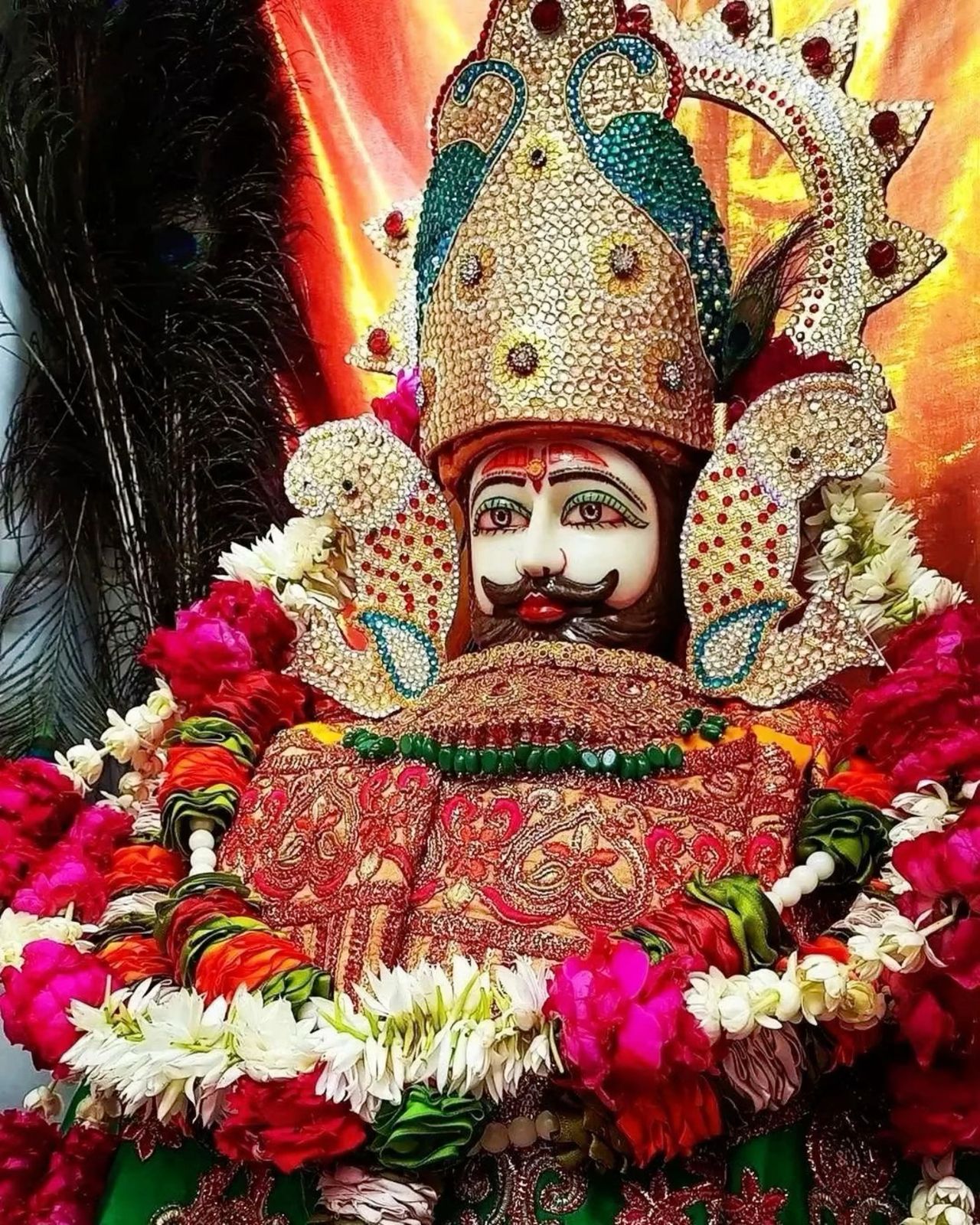 Ramdevpir with ornate crown and flowers