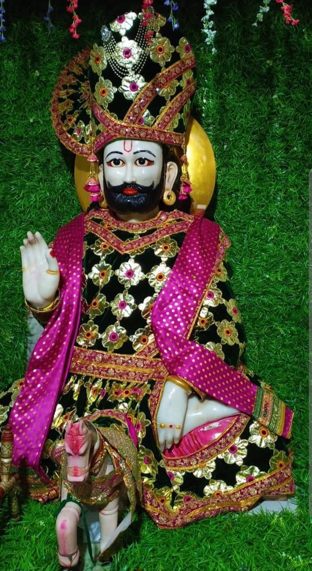Ramdevpir seated in regal attire