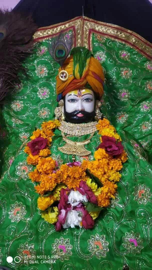 Ramdevpir adorned with flowers and turban