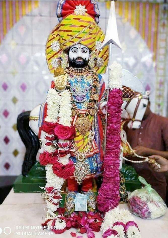 Ramdevpir with traditional headgear and weapon