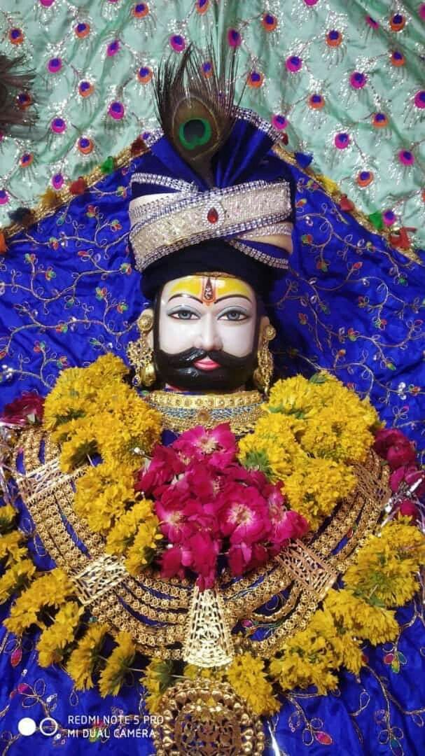 Divine Ramdevpir portrait with floral adornments