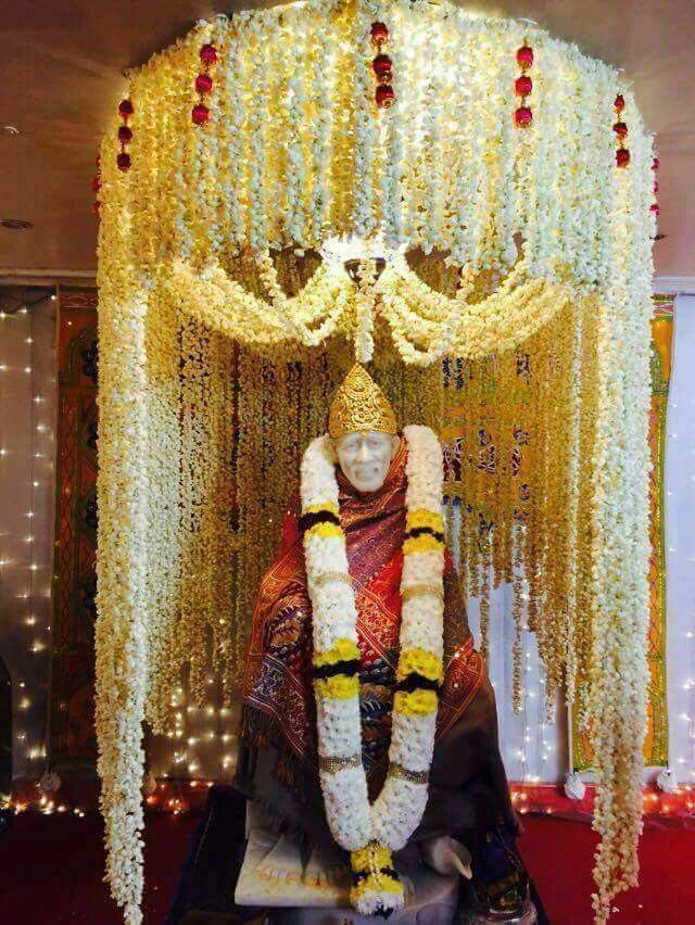 Sai Baba adorned with flower garlands.