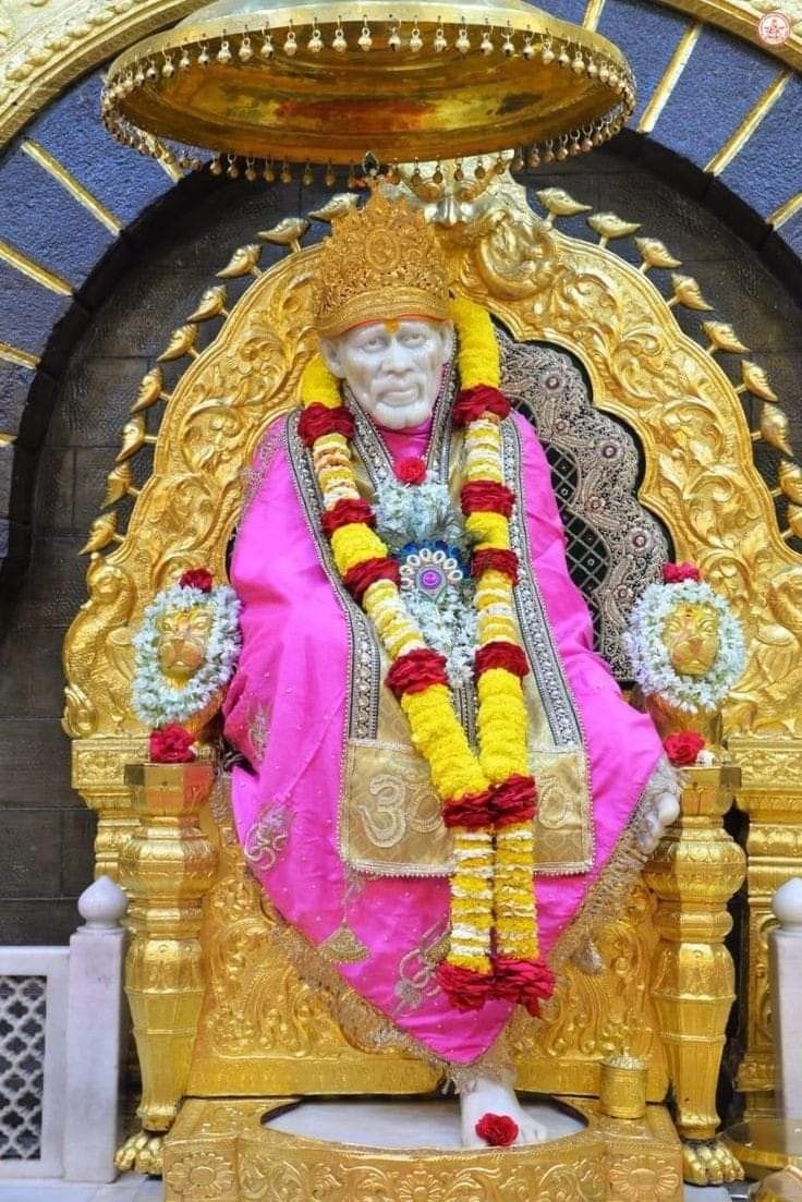 Sai Baba seated on a golden throne