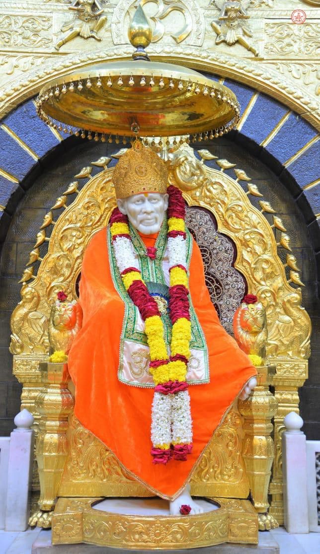 Sai Baba seated on a golden throne